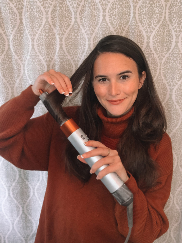 Cortney holding Dyson Airwrap and curling hair
